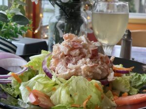 Fresh-picked lobster salad over our garden mix with crisp iceberg, red onion slices, shredded carrots, and tomatoes